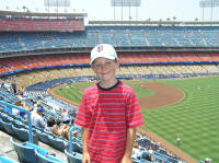 Scottie poses at Dodger Stadium with my beloved red upper deck seats in the background
